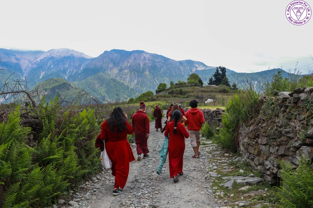 The group walking a mountain trail together during a Himalayan retreat