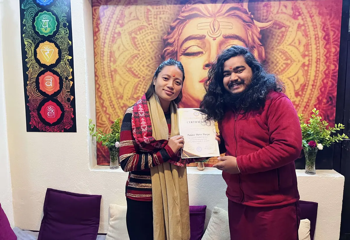 A graduate receiving her certificate after completing teacher training at Jivan Parivartan, Kathmandu