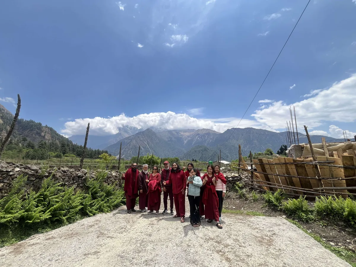 The retreat group standing together on a hill path under an open sky